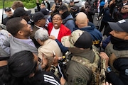 Ice agents surround U.S. Rep LaMonica McIver (red jacket), U.S. Rep Bonnie Coleman (tan jacket) , and Newark Mayor Ras Baraka outside Delaney Hall in Newark on Friday, May 9, 2025.