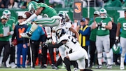 Philadelphia Eagles running back Saquon Barkley (26) leaps backwards over Jacksonville Jaguars cornerback Jarrian Jones (22) during the NFL football game, Sunday, Nov. 3, 2024, in Philadelphia. The Eagles won 28-23.